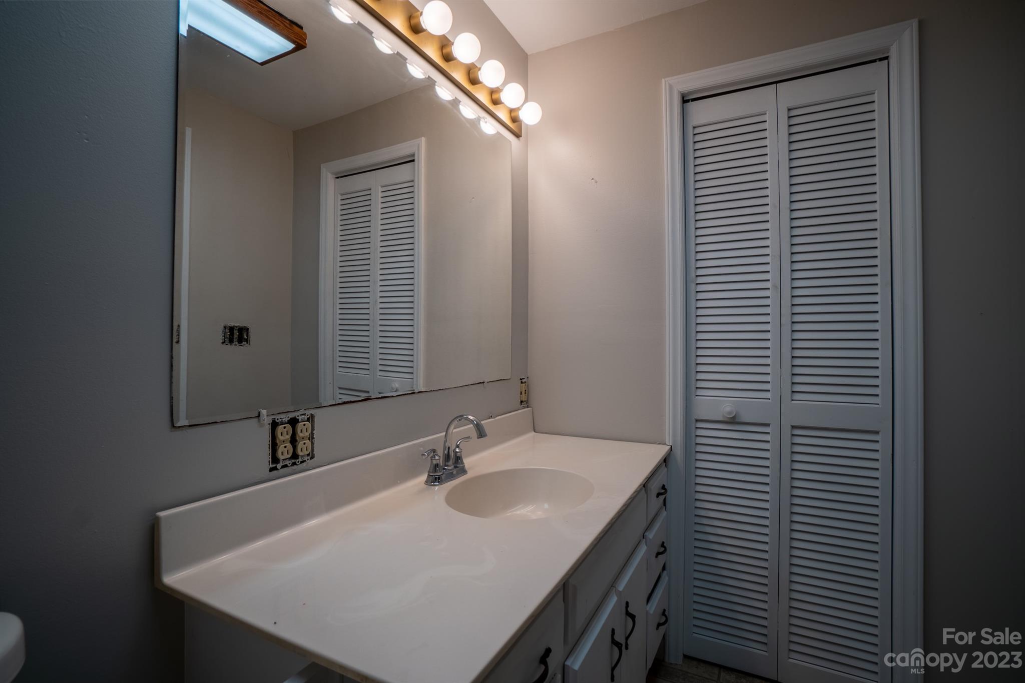 17158 Pond Road Locust, NC 28097 - Photo 17 of 28 a bathroom with a sink and a mirror