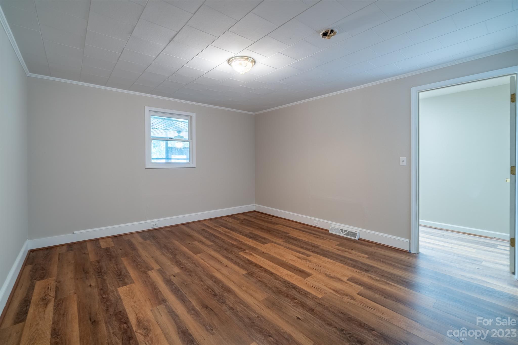 17158 Pond Road Locust, NC 28097 - Photo 18 of 28 wooden floor in an empty room with a window
