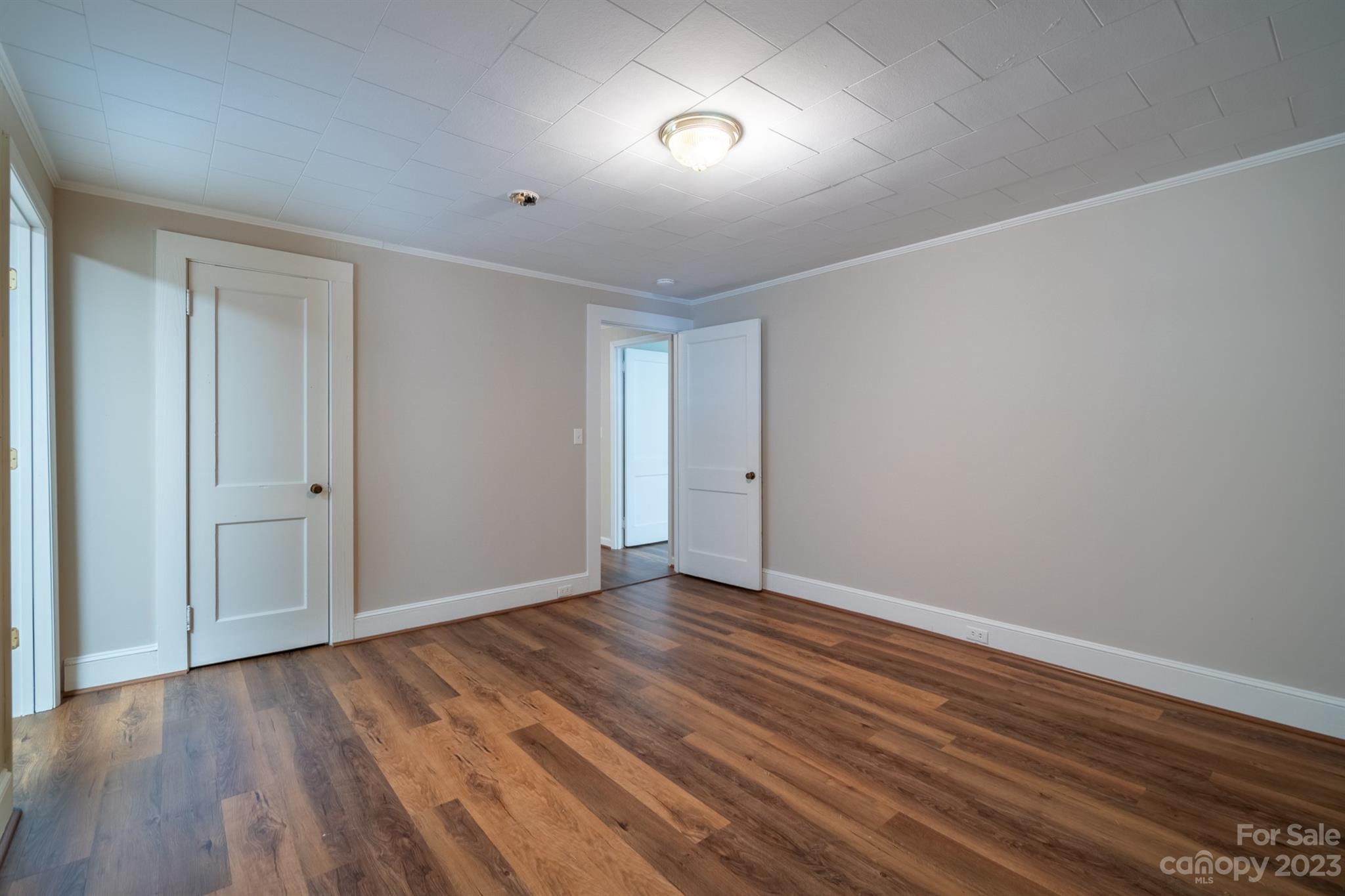 17158 Pond Road Locust, NC 28097 - Photo 19 of 28 a view of an empty room with wooden floor