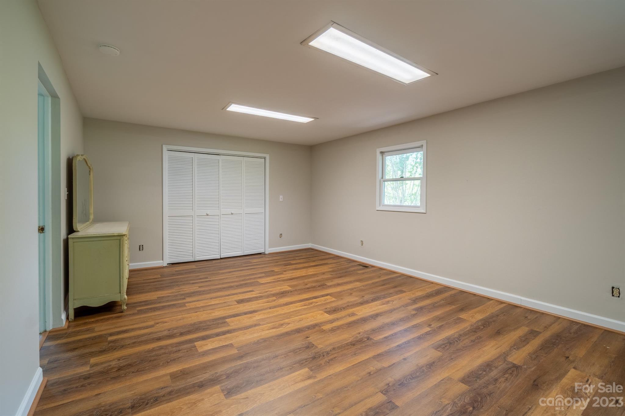 17158 Pond Road Locust, NC 28097 - Photo 20 of 28 a view of empty room with wooden floor and fan
