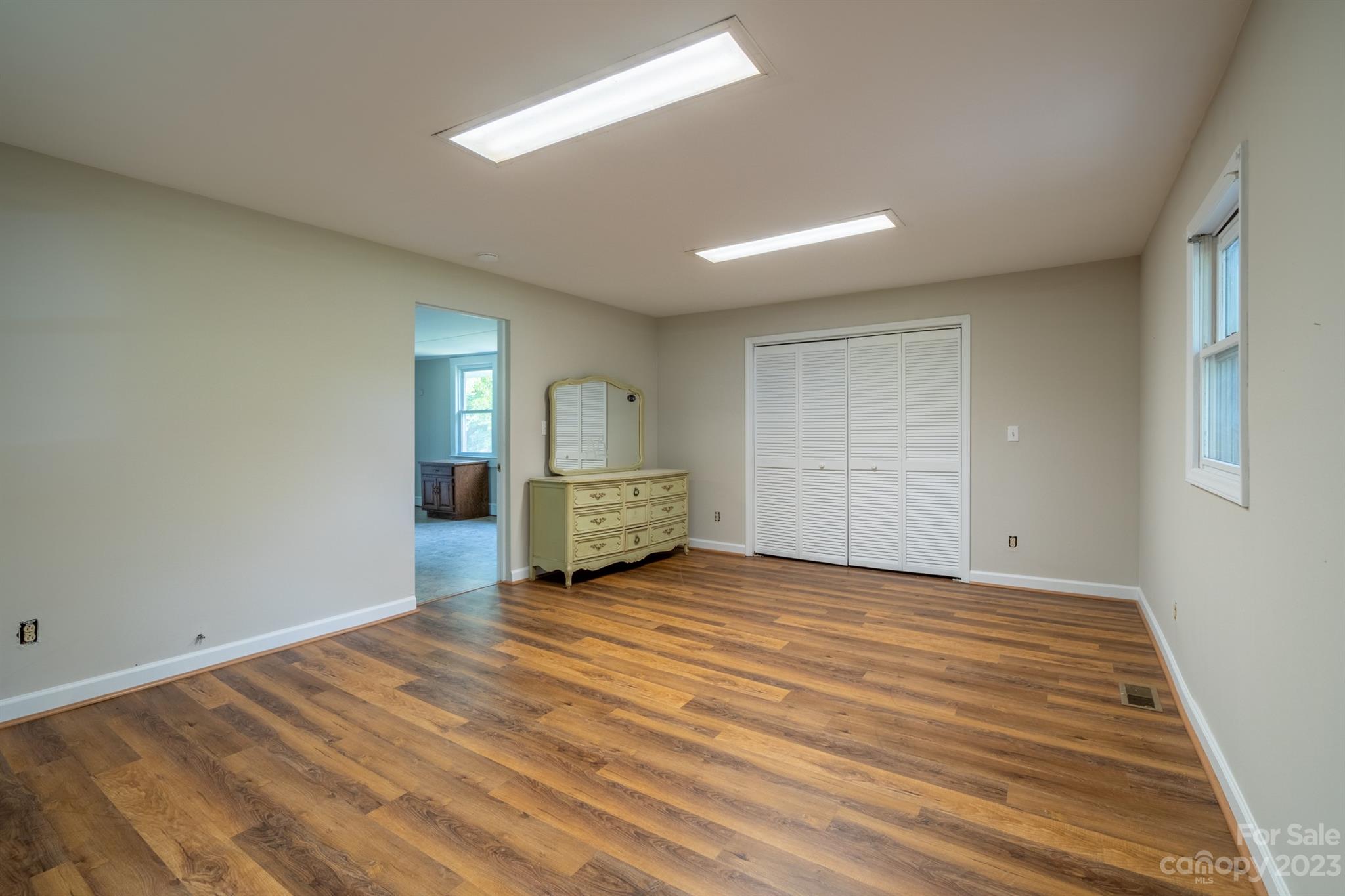 17158 Pond Road Locust, NC 28097 - Photo 21 of 28 a view of an empty room with wooden floor closet and a window