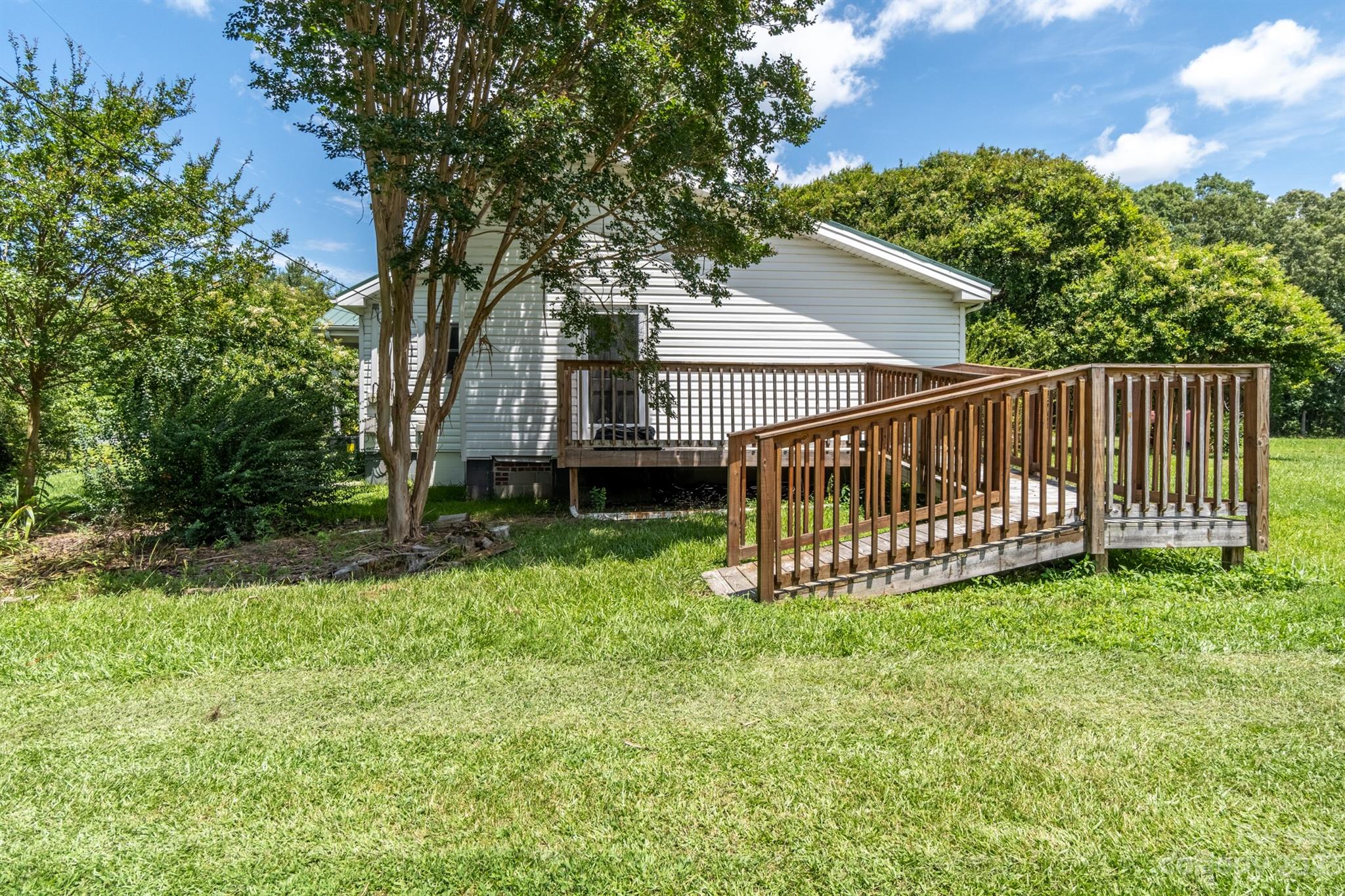 17158 Pond Road Locust, NC 28097 - Photo 25 of 28 a view of a house with a yard and a deck