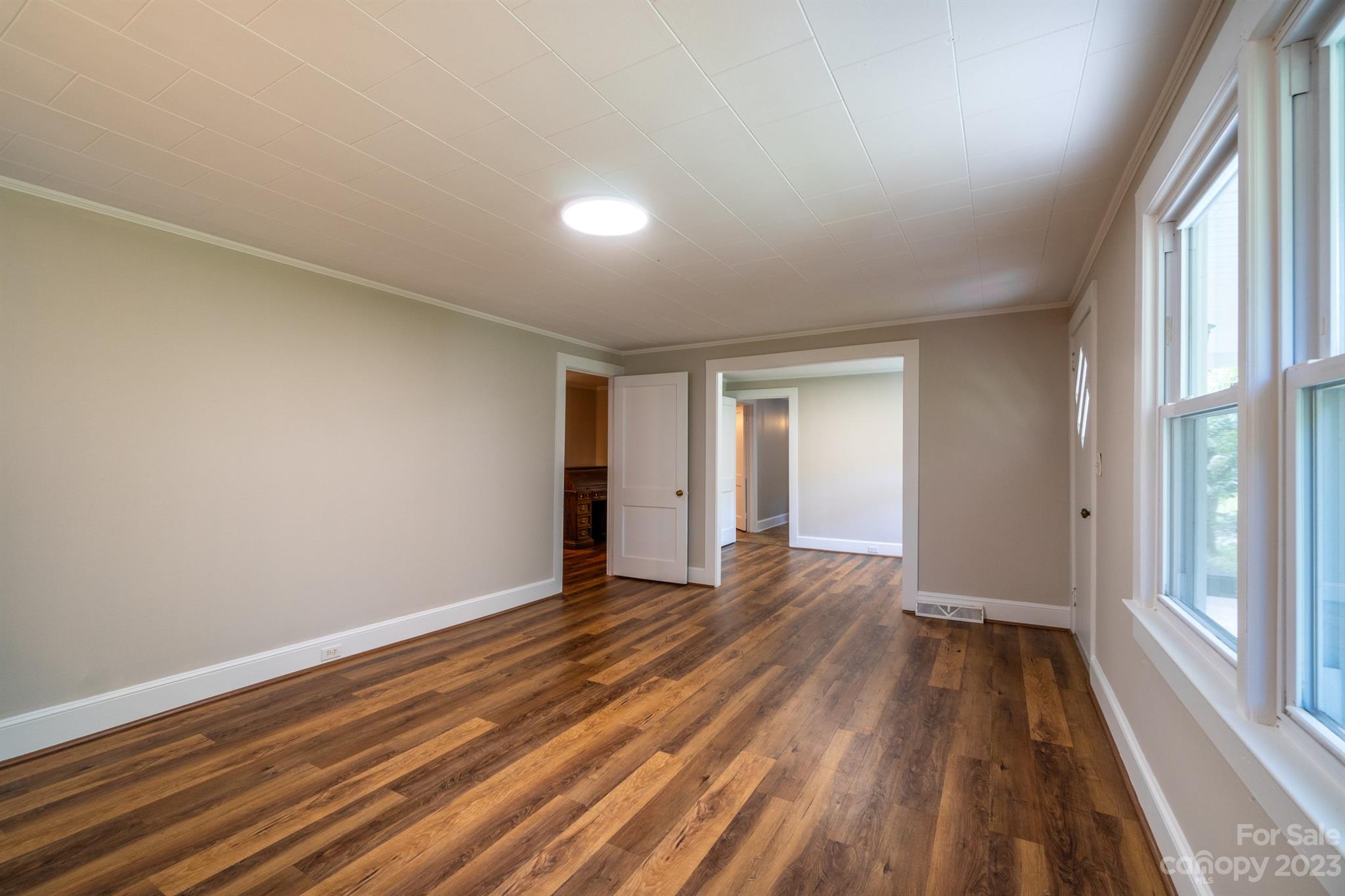 17158 Pond Road Locust, NC 28097 - Photo 6 of 28 a view of an empty room with wooden floor and a window
