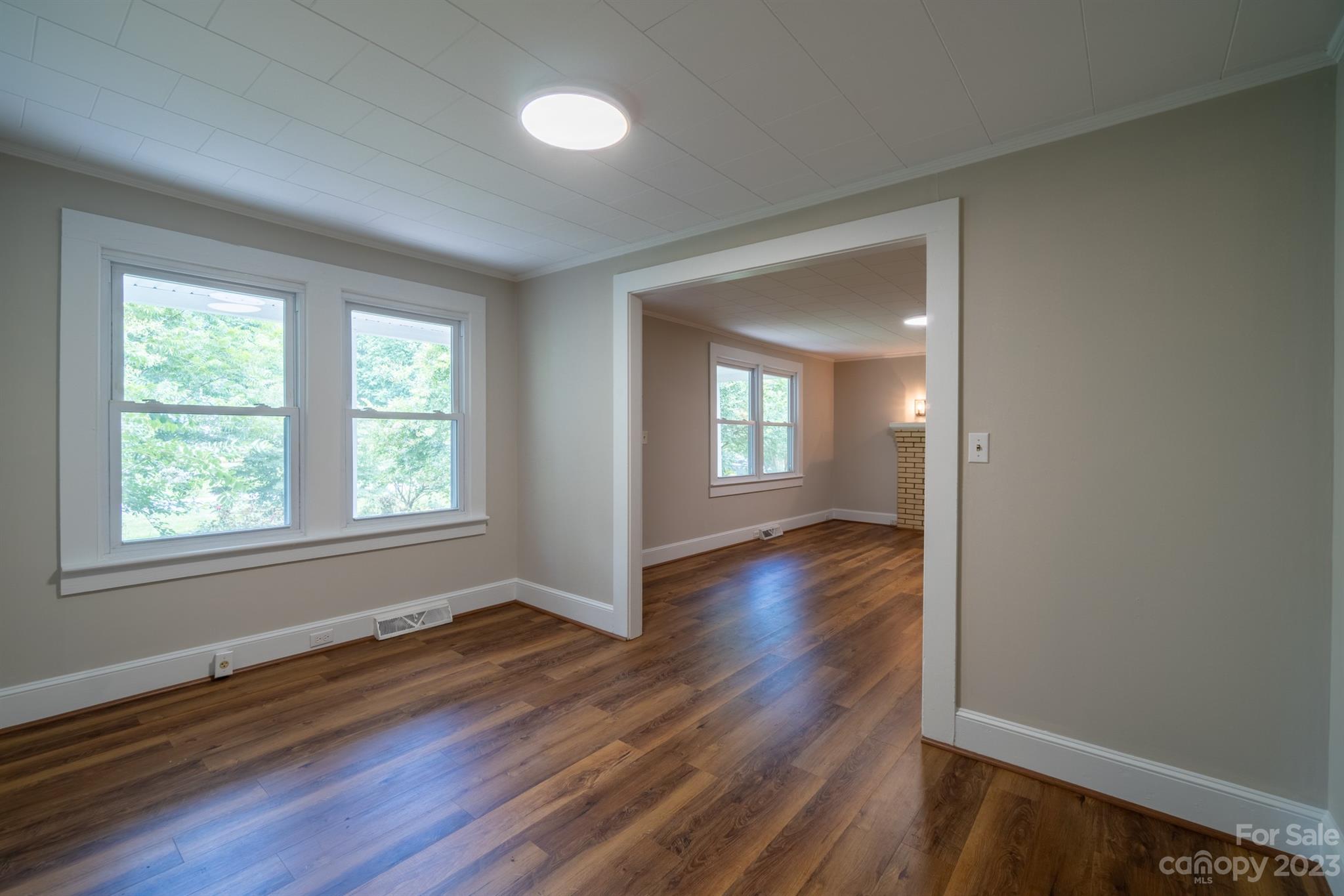 17158 Pond Road Locust, NC 28097 - Photo 8 of 28 an empty room with wooden floor and windows