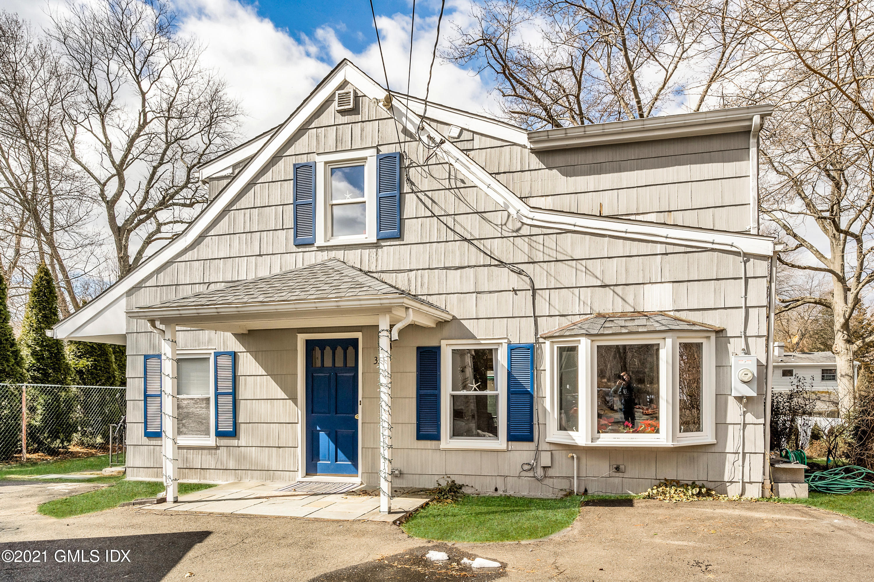 front view of a brick house with a yard