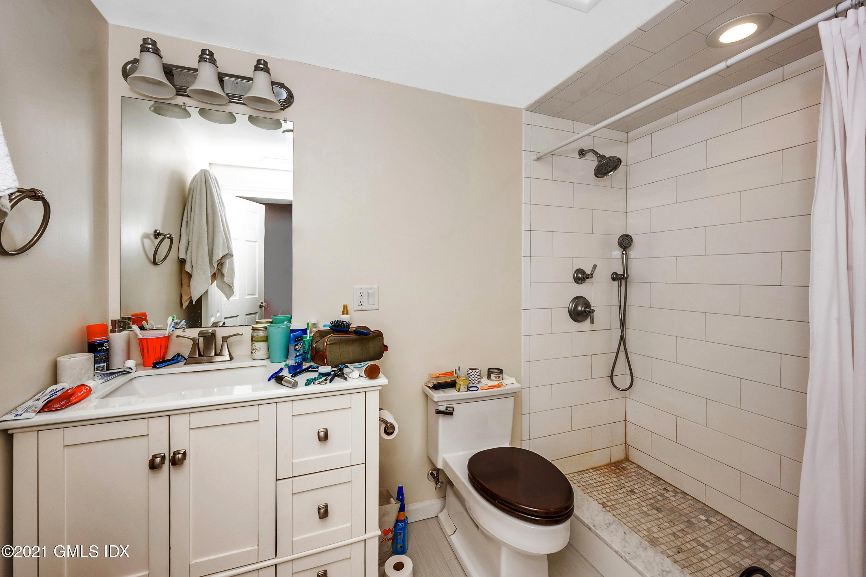 33 Sunshine Avenue Riverside, CT 06878 - Photo 12 of 18 a bathroom with a sink a toilet and a mirror