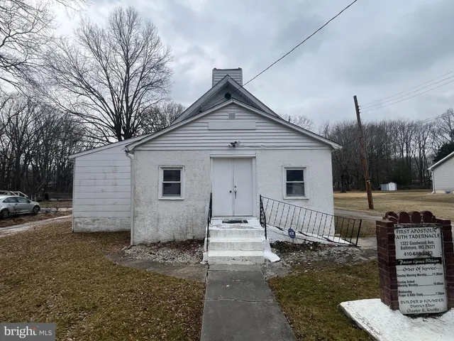 a view of a house with wooden fence