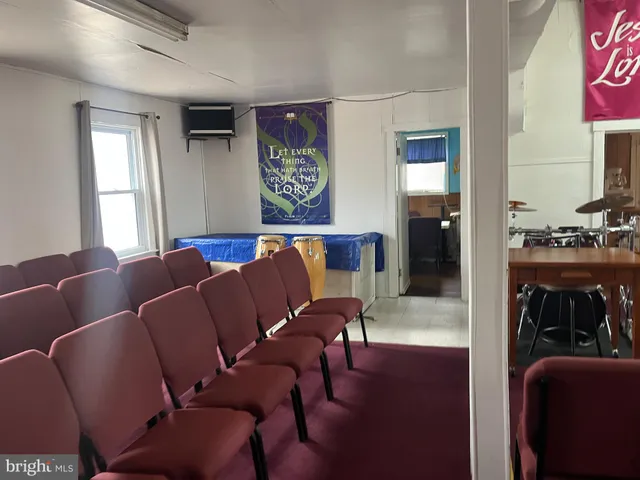 a living room with furniture and painting on the wall