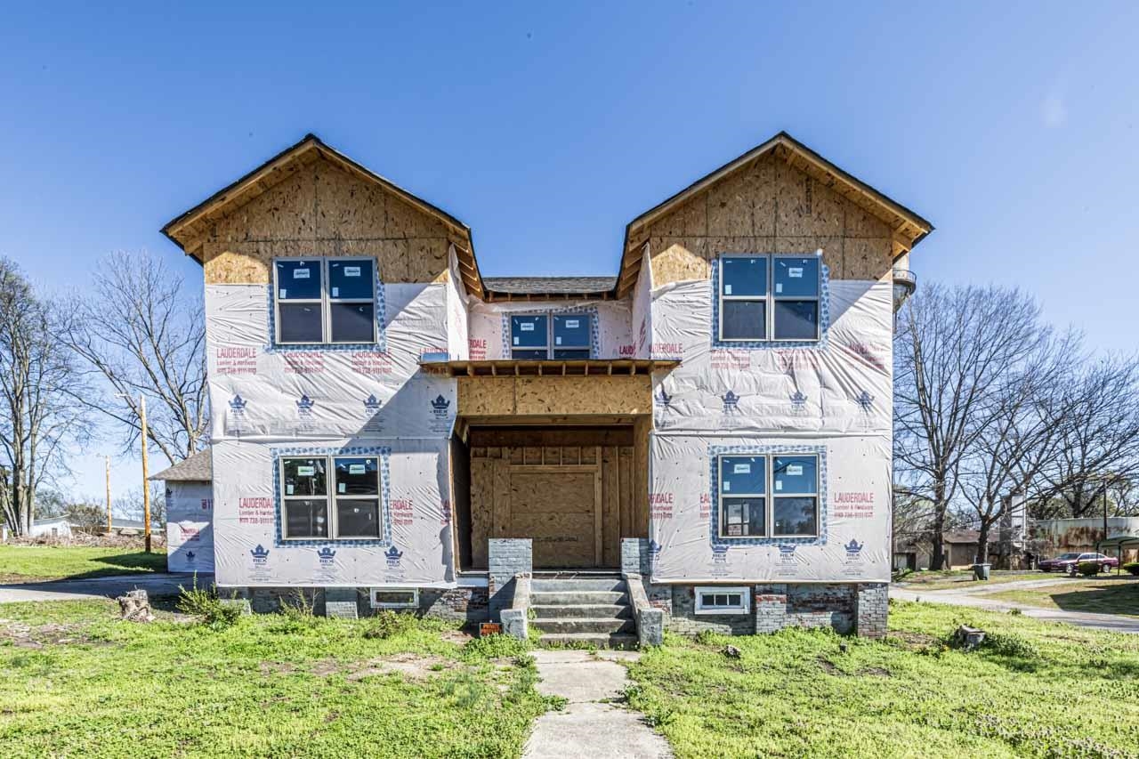 Property under construction with a front yard