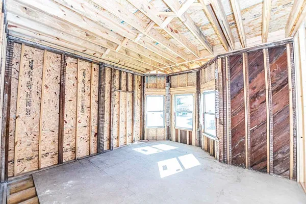 a view of an entryway with wooden floor and brick walls