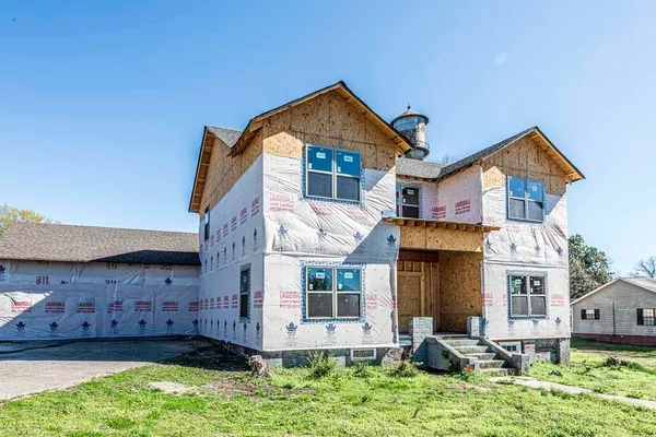 front view of a house with a yard