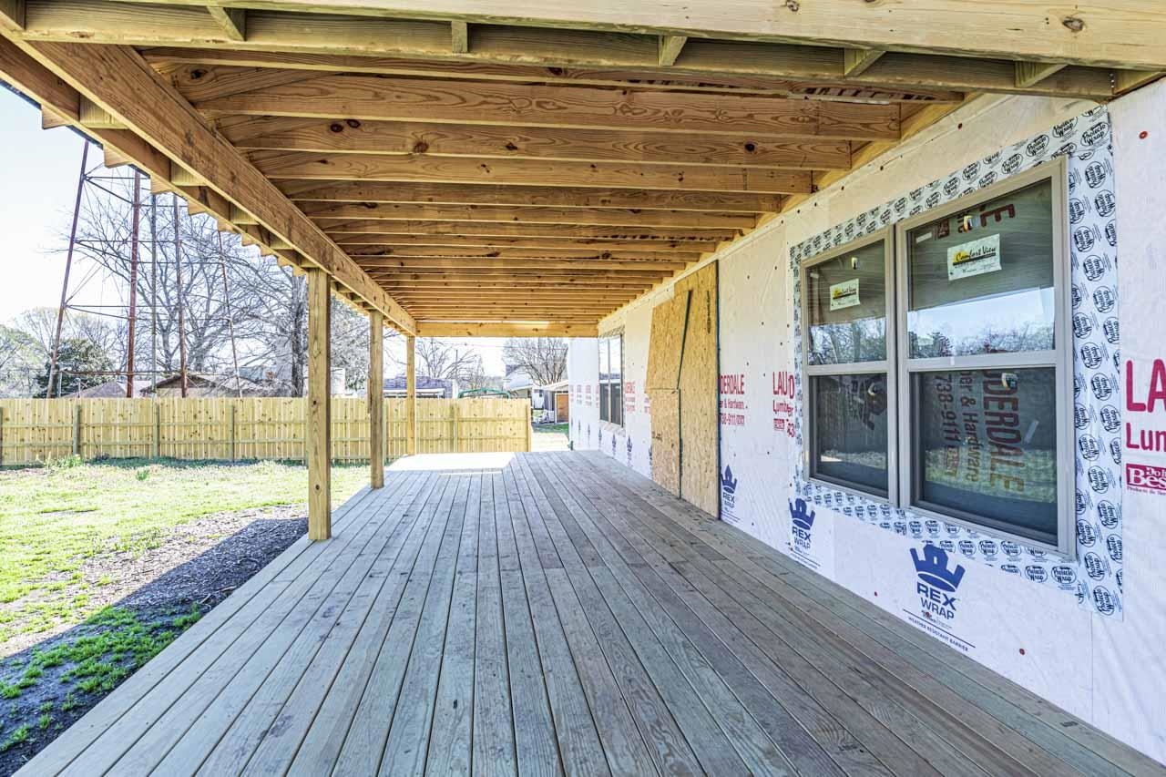 400 Barfield Avenue Henning, TN 38041 - Photo 6 of 39 a view of an empty room with wooden floor and a floor to ceiling window