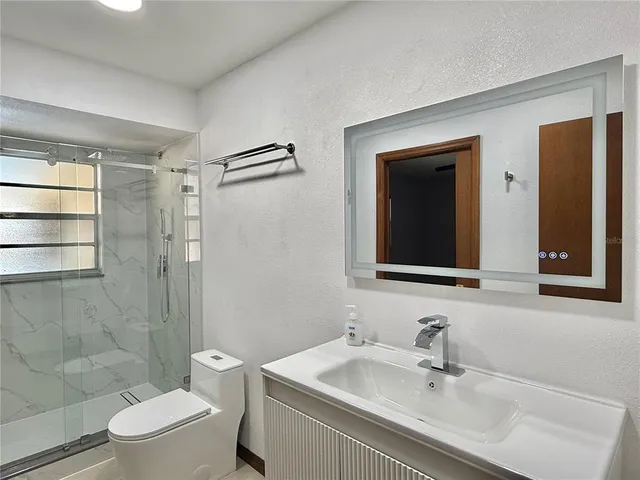 an empty room with a window and a ceiling fan