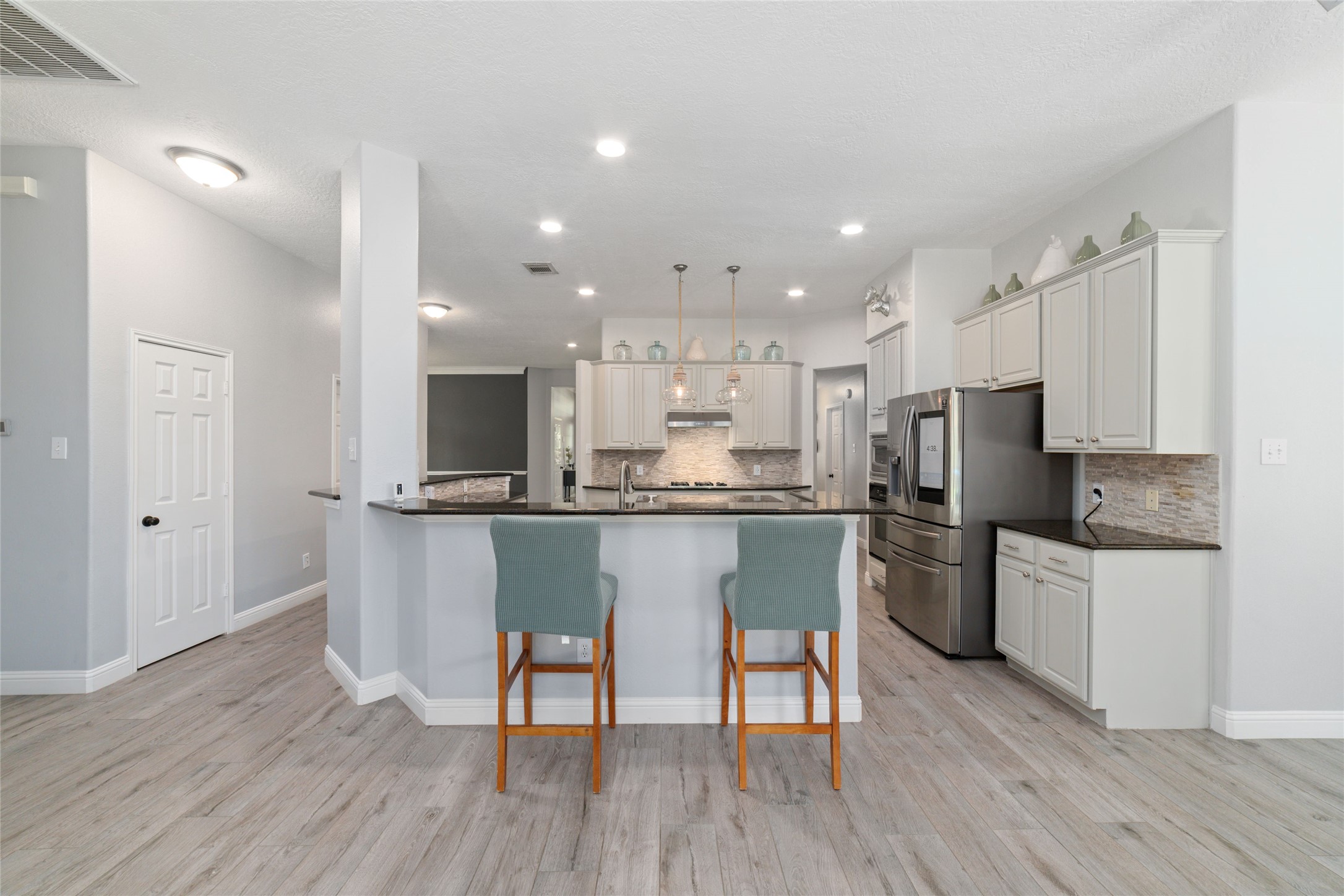 24203 Moon Ridge Court Katy, TX 77494 - Photo 15 of 43 From the living room you can see the breakfast bar. Perfect for on the go moments or just hanging out together in the kitchen.
