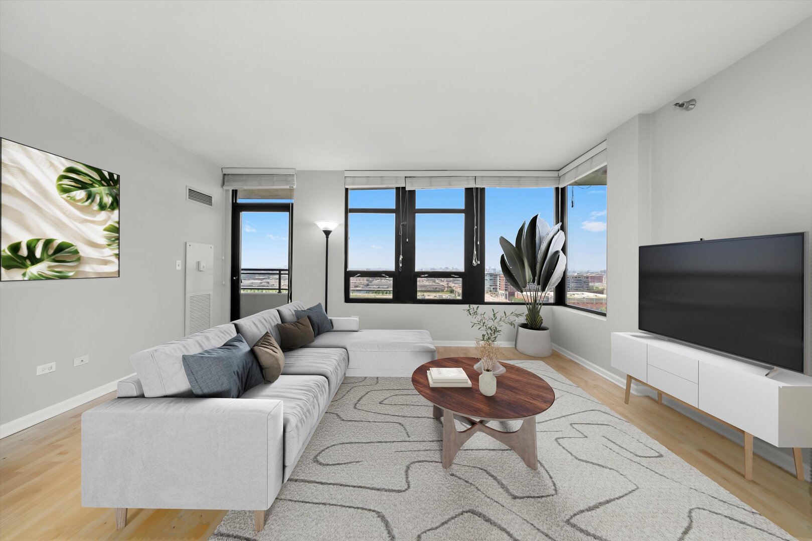 1255 South State Street, Unit 1702 Chicago, IL 60605 - Photo 14 of 36 a living room with furniture and a flat screen tv