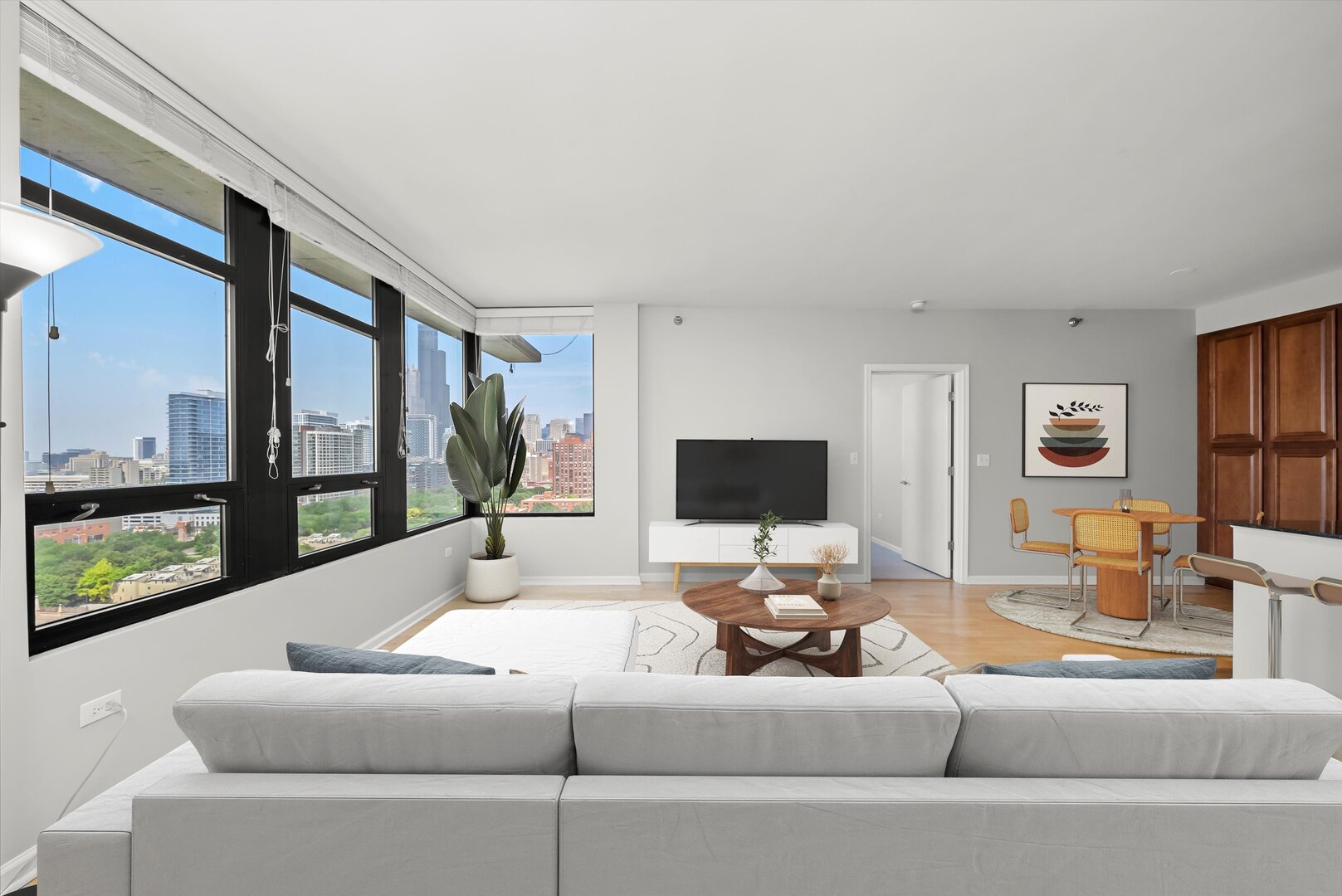 1255 South State Street, Unit 1702 Chicago, IL 60605 - Photo 16 of 36 a living room with furniture and a flat screen tv