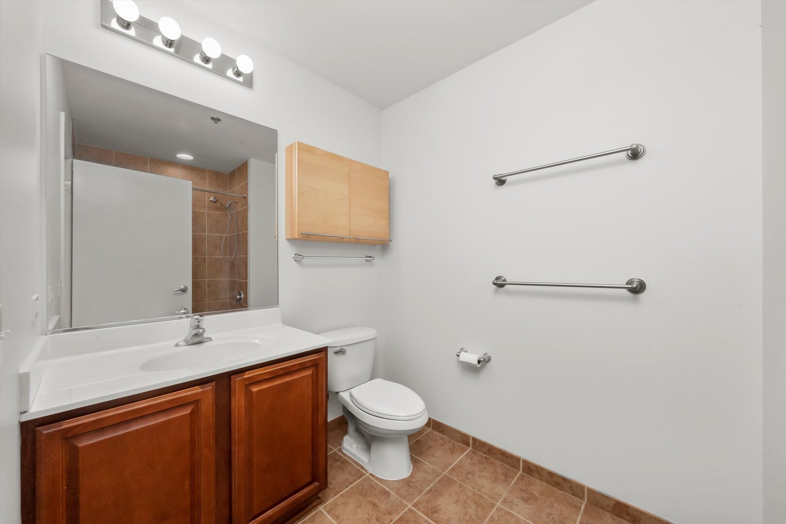 1255 South State Street, Unit 1702 Chicago, IL 60605 - Photo 25 of 36 a bathroom with a toilet sink and mirror