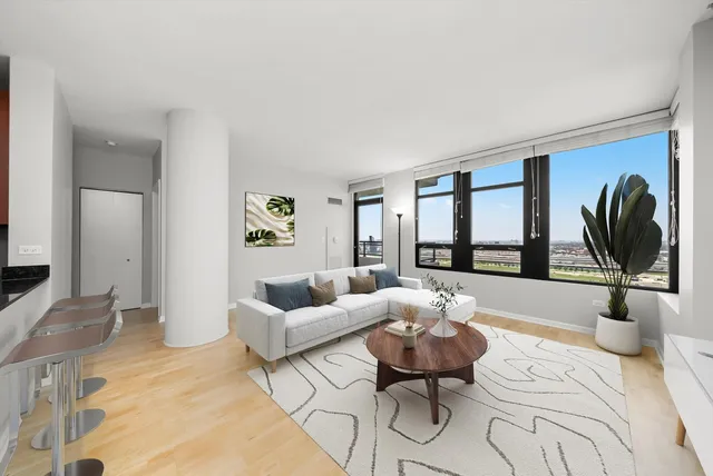a living room with furniture and a large window