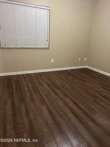a view of a room with wooden floor