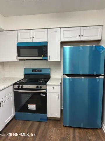 a kitchen with stainless steel appliances a stove and a refrigerator