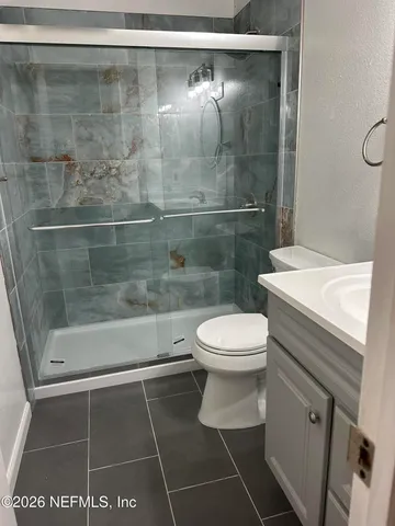 a bathroom with a toilet and a shower