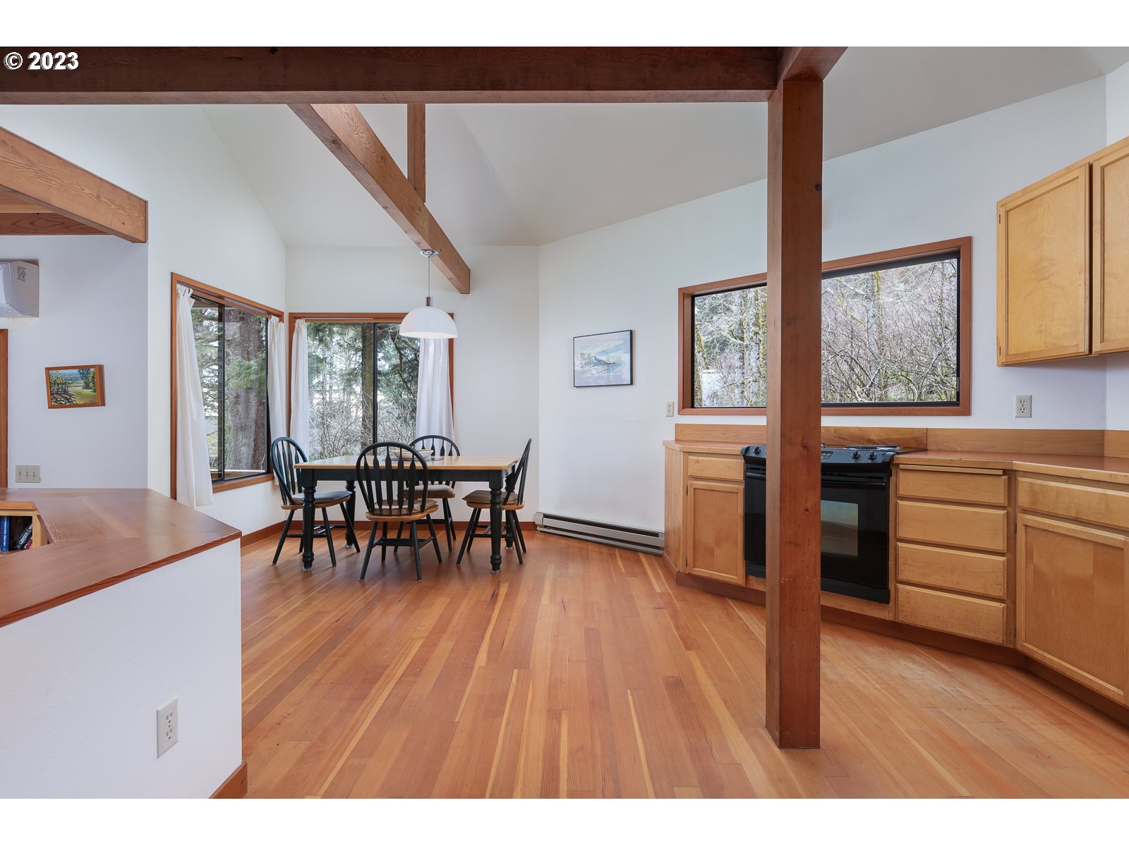 2170 Old Ranch Road Otis, OR 97368 - Photo 12 of 32 a living room with furniture and a dining table with wooden floor