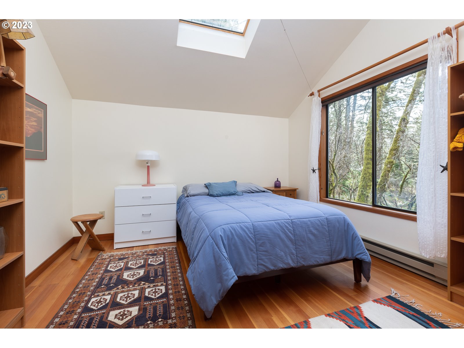 2170 Old Ranch Road Otis, OR 97368 - Photo 17 of 32 a bedroom with a bed and a large window