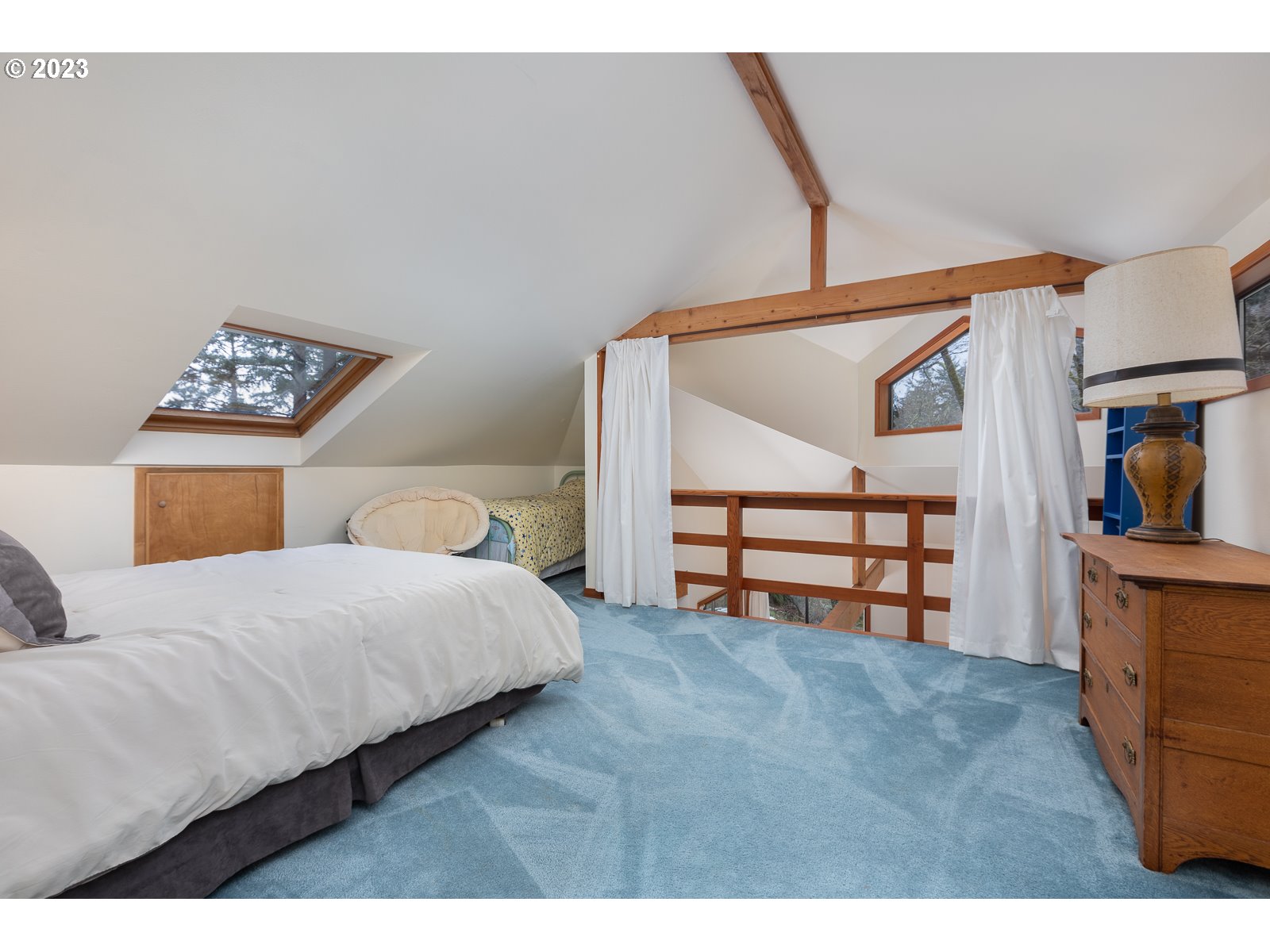 2170 Old Ranch Road Otis, OR 97368 - Photo 21 of 32 a bedroom with a bed and a painting on the wall