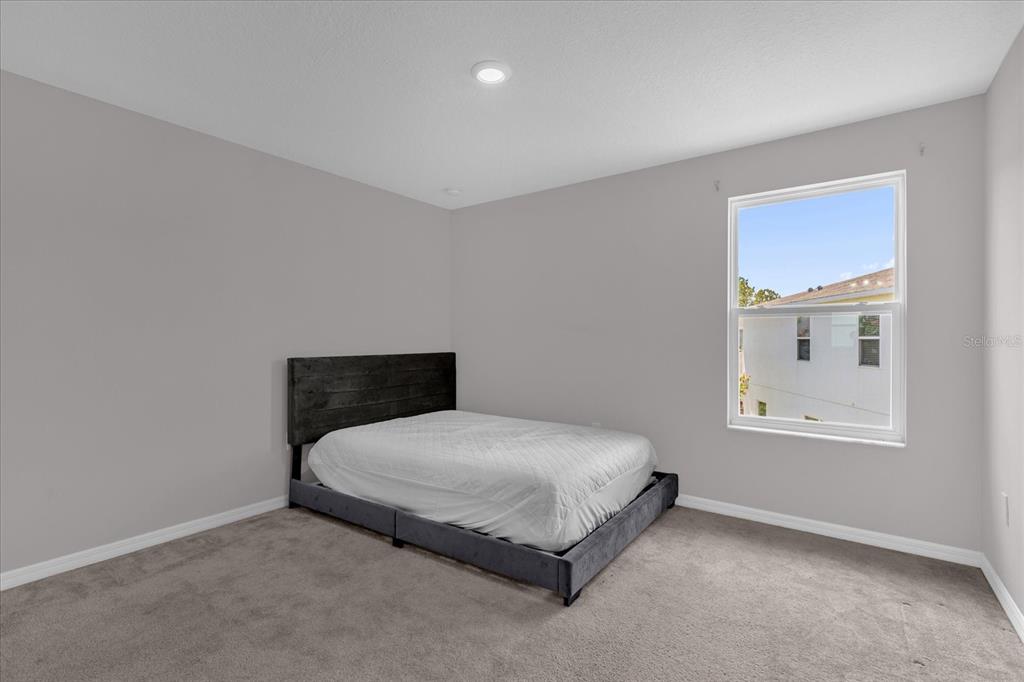 3470 Beau Road Kissimmee, FL 34746 - Photo 27 of 40 a bedroom with a bed and window