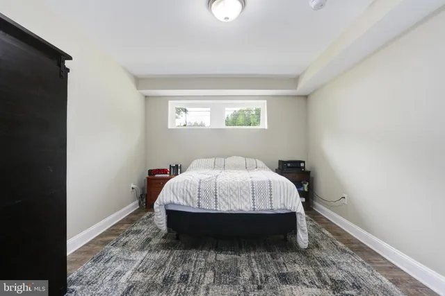 a bed sitting in a bedroom next to a window