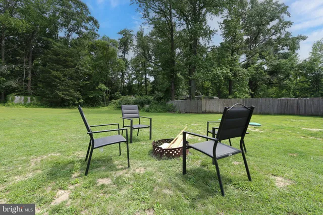 a view of a chairs in a backyard
