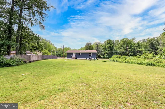 a house view with swimming pool in front of it