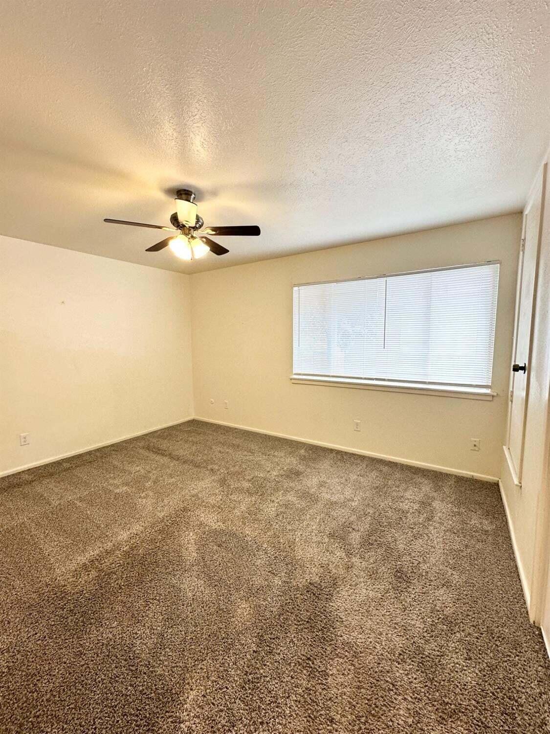 1303 65th Street Lubbock, TX 79412 - Photo 11 of 11 an empty room with a empty space and a ceiling fan