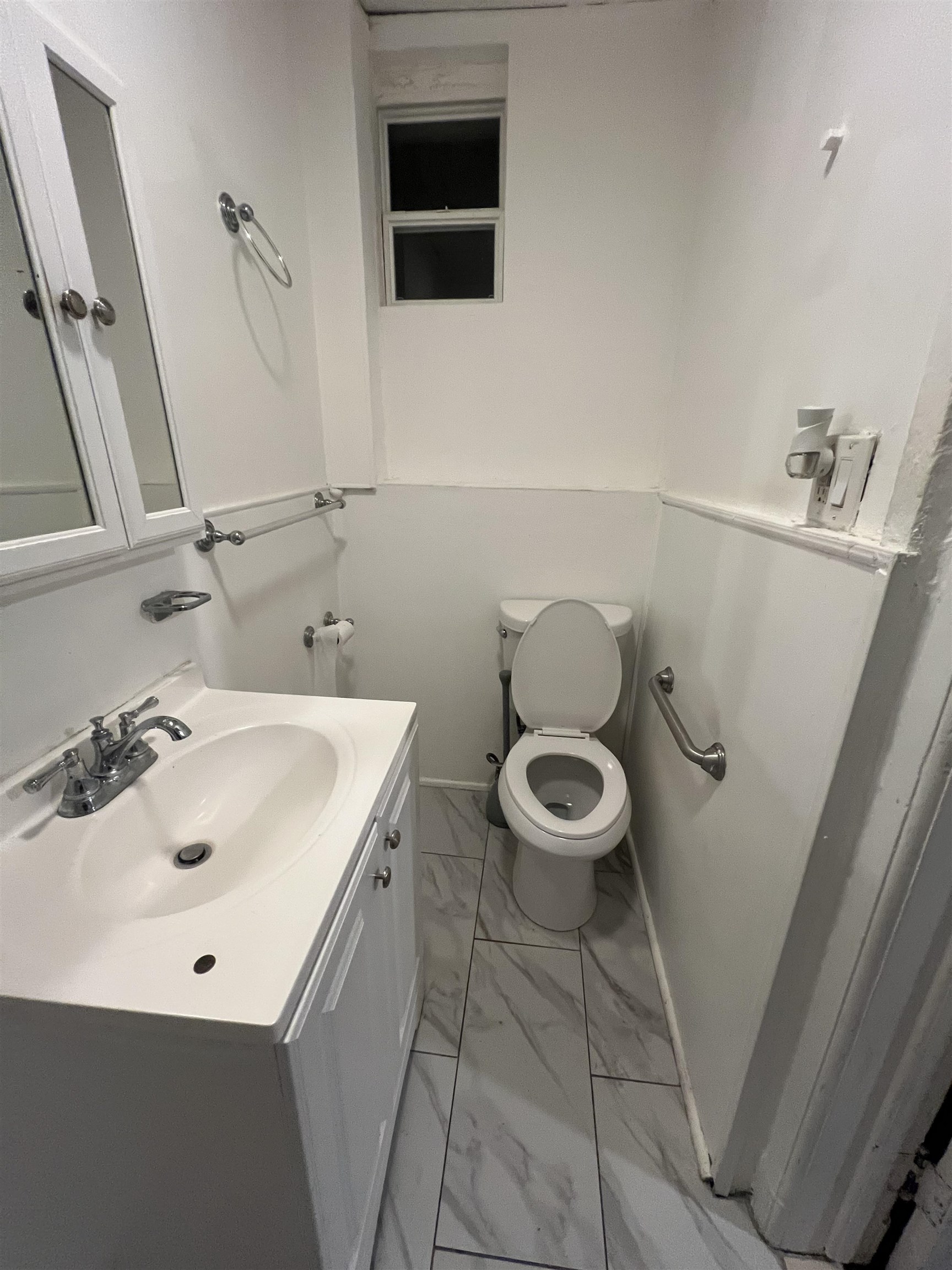 1511 46th Street, Unit 2 North Bergen, NJ 07047 - Photo 12 of 13 a bathroom with a sink a toilet and mirror