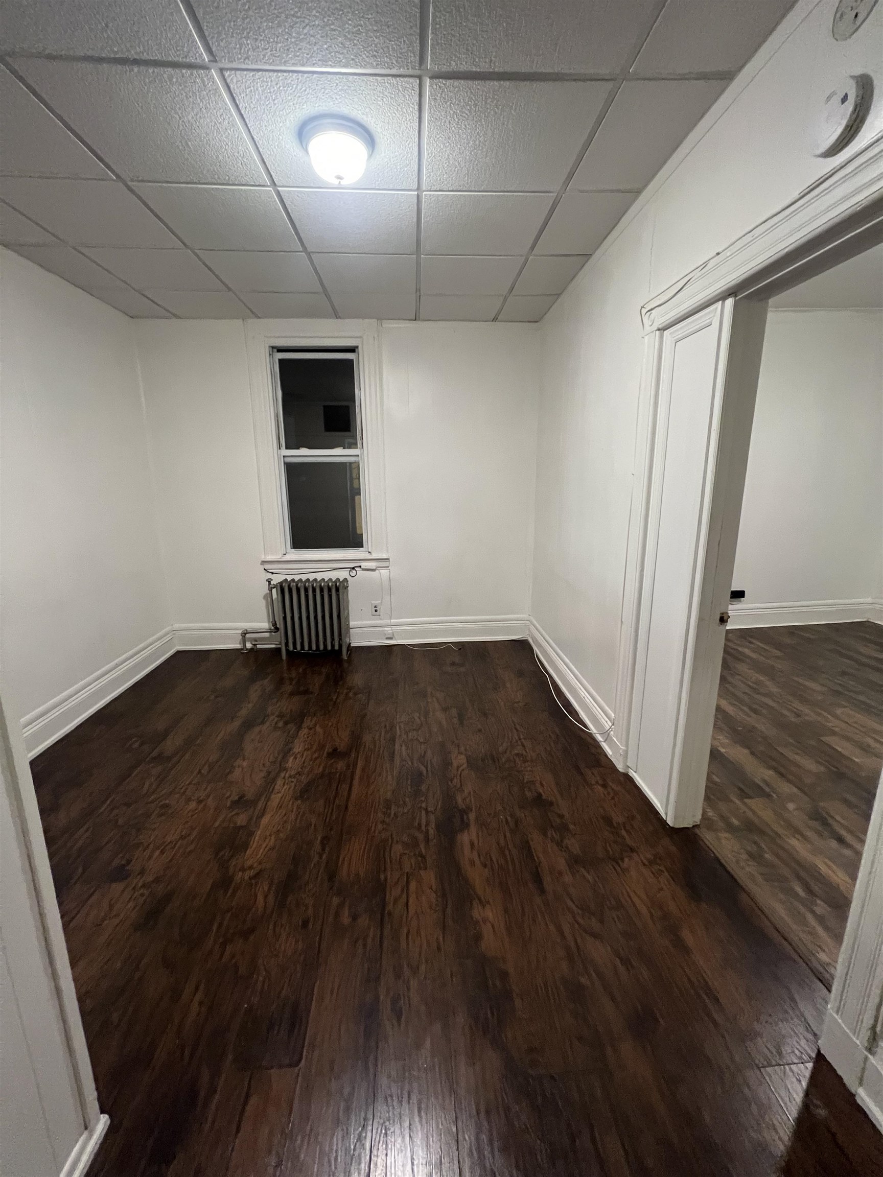 1511 46th Street, Unit 2 North Bergen, NJ 07047 - Photo 6 of 13 an empty room with wooden floor and windows