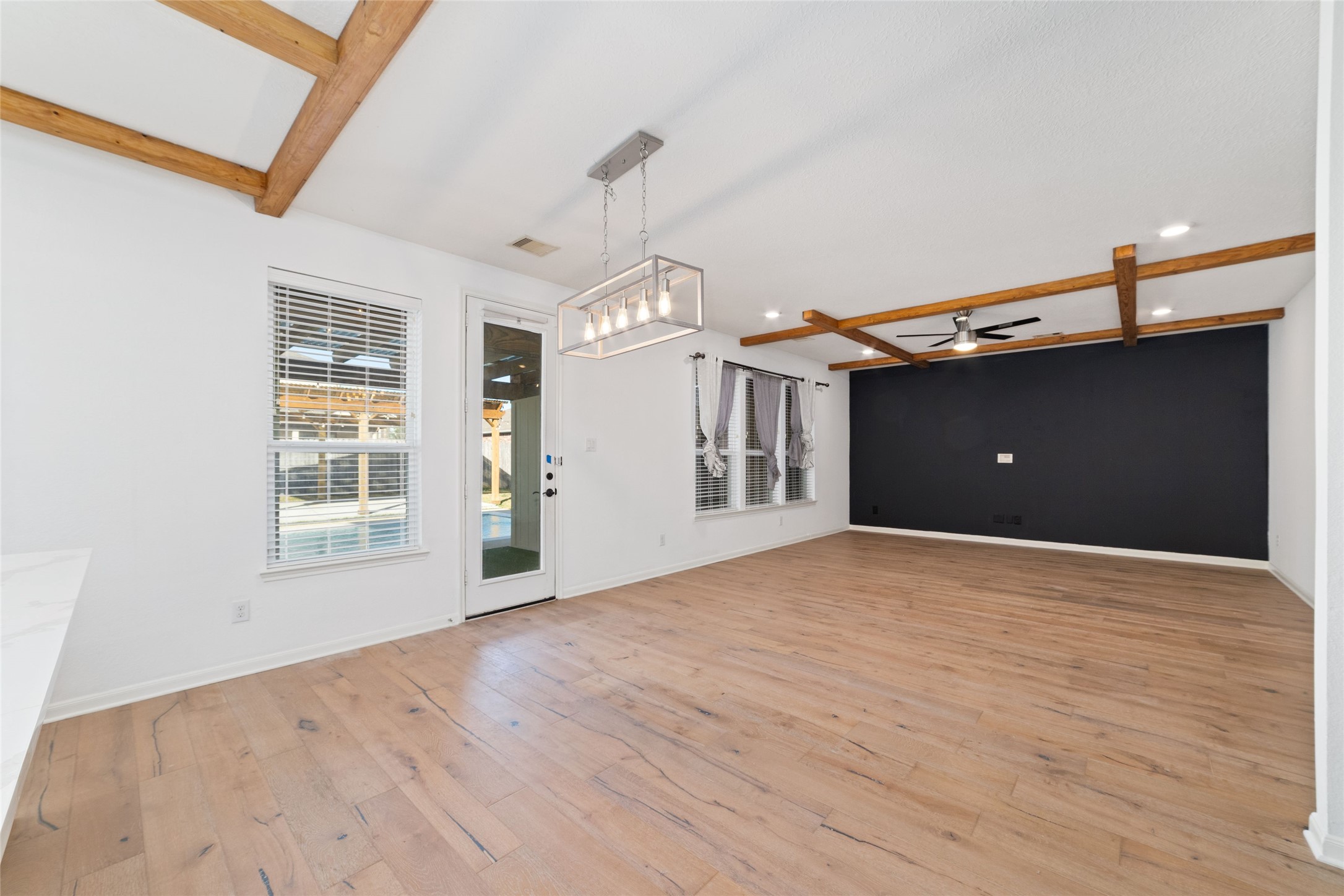 3508 Saxton Green Road Pearland, TX 77584 - Photo 15 of 45 a view of an empty room with a window and wooden floor