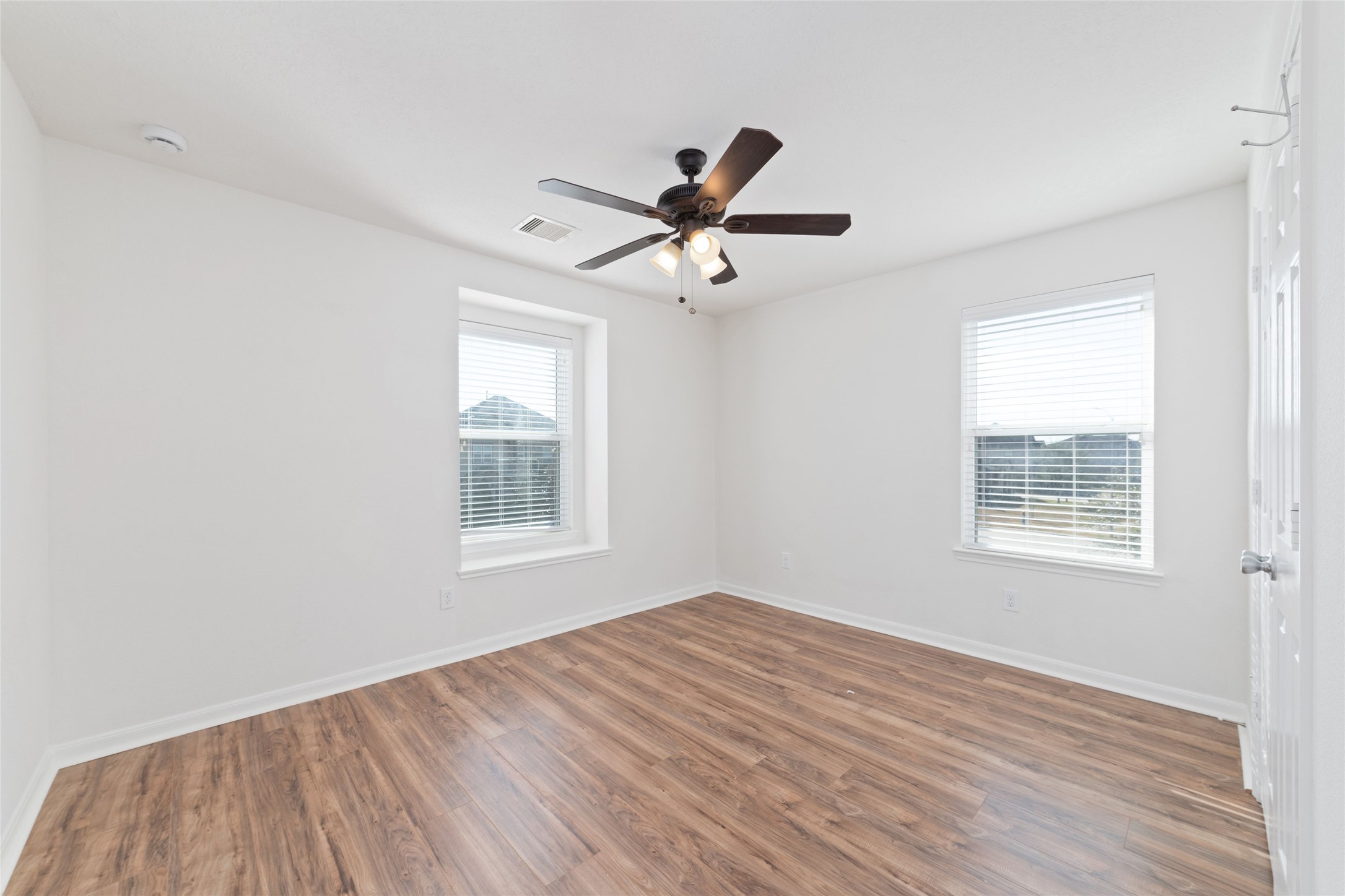 3508 Saxton Green Road Pearland, TX 77584 - Photo 22 of 45 a view of an empty room with wooden floor and a window