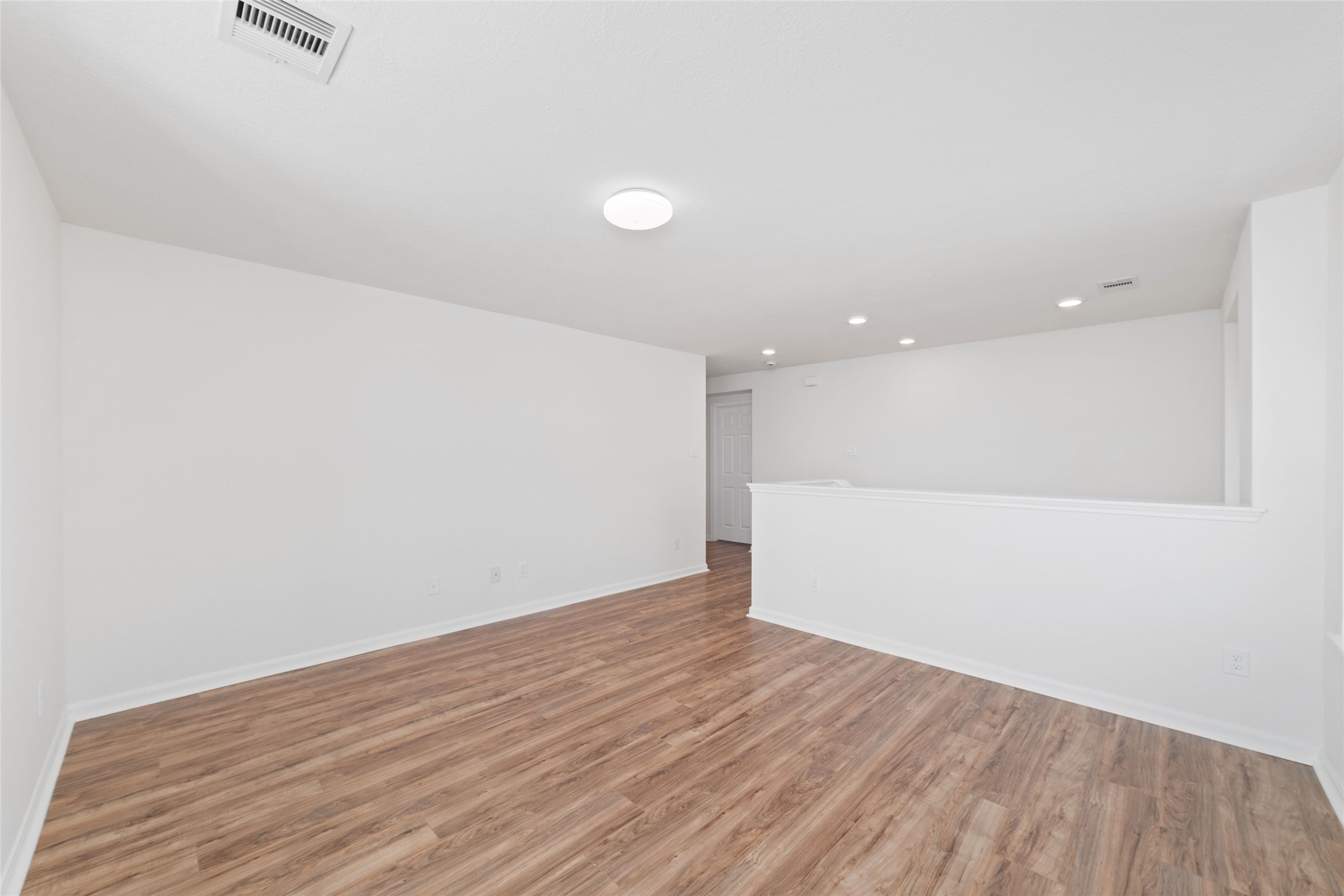 3508 Saxton Green Road Pearland, TX 77584 - Photo 25 of 45 an empty room with wooden floor and windows