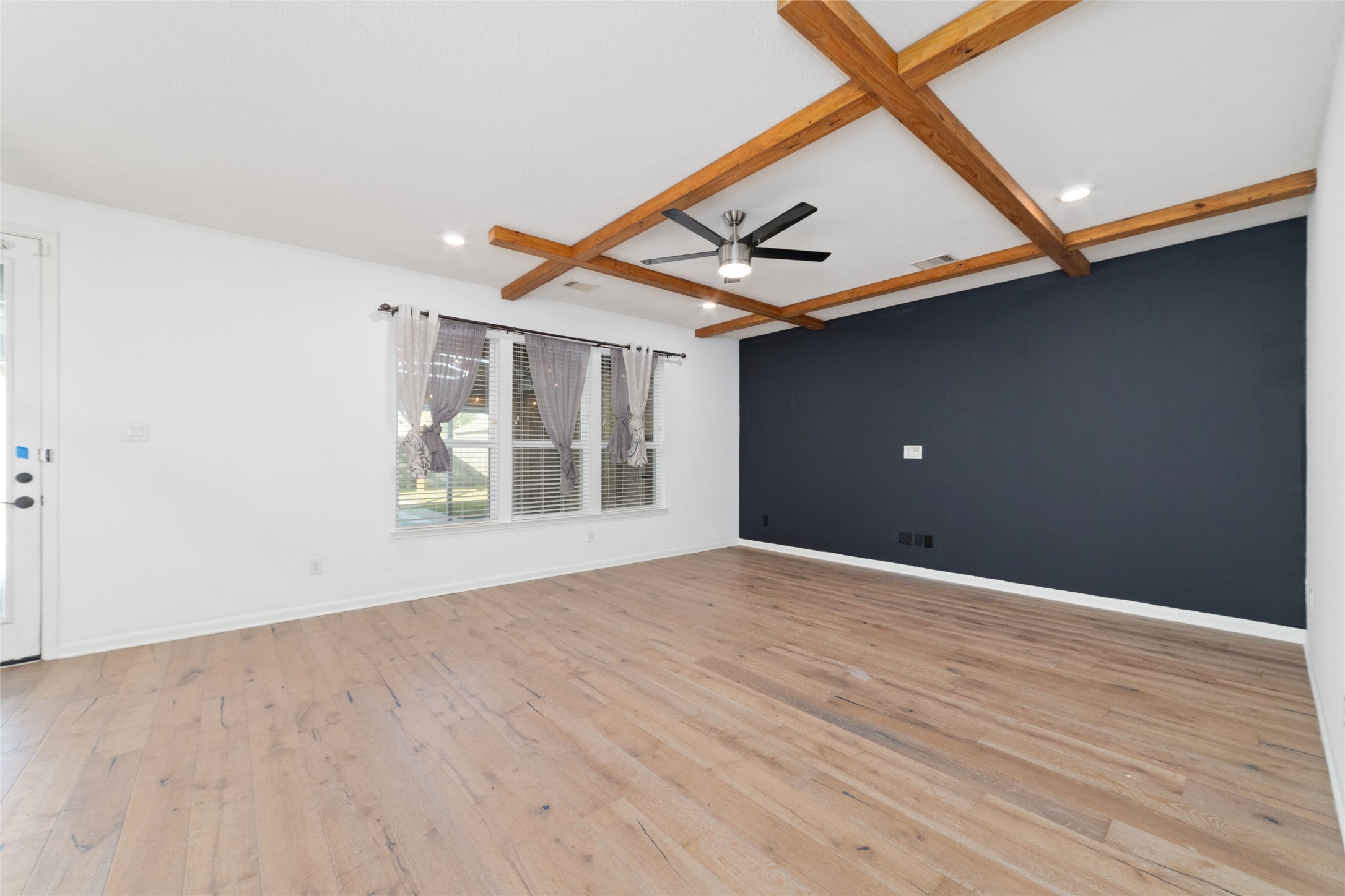 3508 Saxton Green Road Pearland, TX 77584 - Photo 9 of 45 an empty room with wooden floor and windows