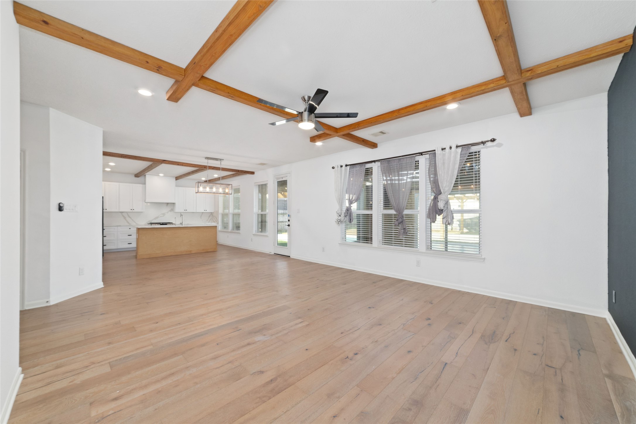 3508 Saxton Green Road Pearland, TX 77584 - Photo 10 of 45 a view of a livingroom with wooden floor and a ceiling fan