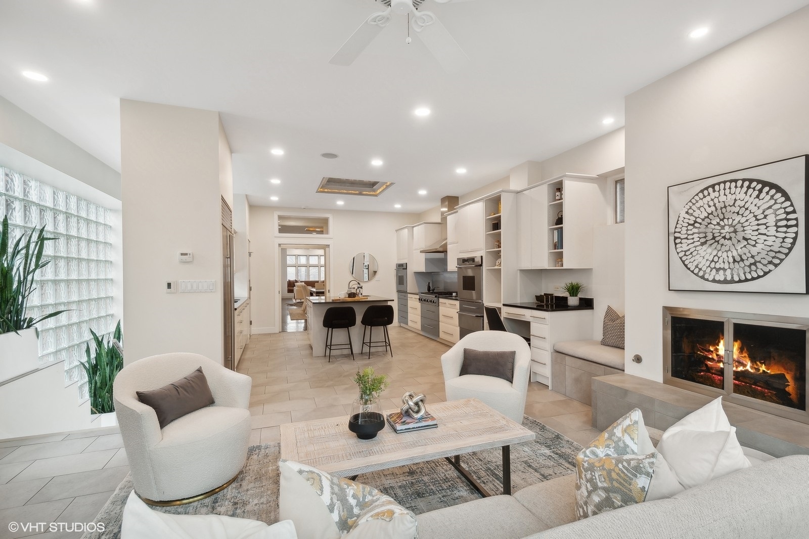 1261 West Flournoy Street Chicago, IL 60607 - Photo 11 of 43 a living room with furniture kitchen view and a fireplace