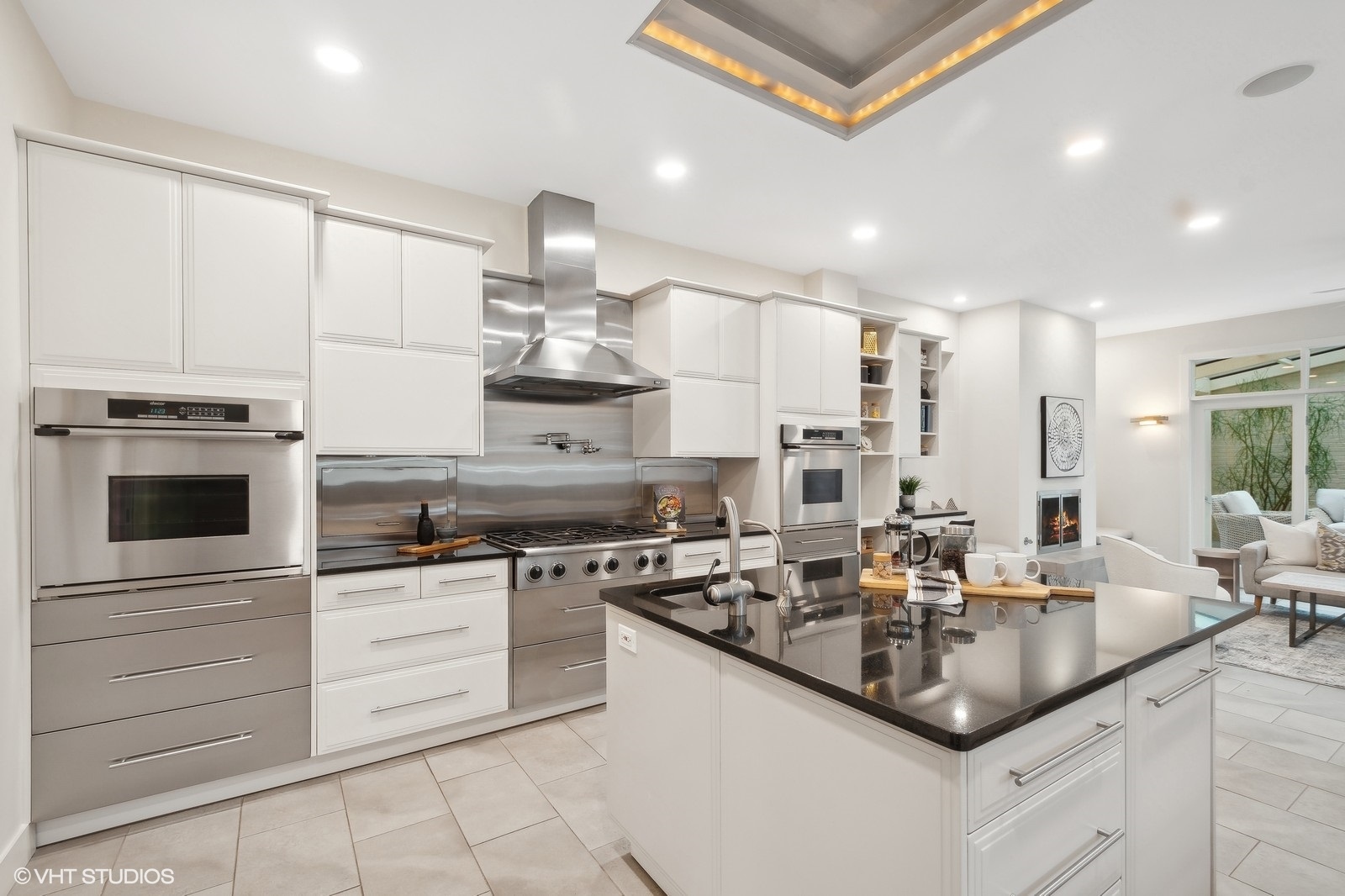 1261 West Flournoy Street Chicago, IL 60607 - Photo 8 of 43 a kitchen with kitchen island granite countertop a sink stainless steel appliances and cabinets