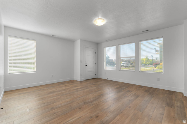 8307 Durham Street Sandy, UT 84070 - Photo 23 of 29 Spacious room featuring wood-finish flooring, white baseboards, and a neutral color palette