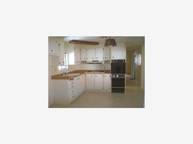 11 Lighthouse Road, Unit 11 Half Moon Bay, CA 94019 - Photo 2 of 6 a kitchen with a sink and cabinets