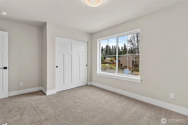 an empty room with windows and closet