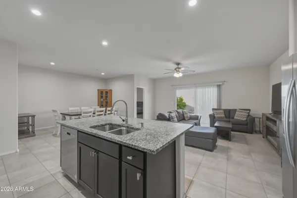 a living room with granite countertop furniture and a kitchen view