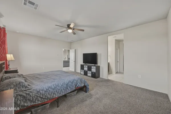 a bedroom with a bed and a flat screen tv