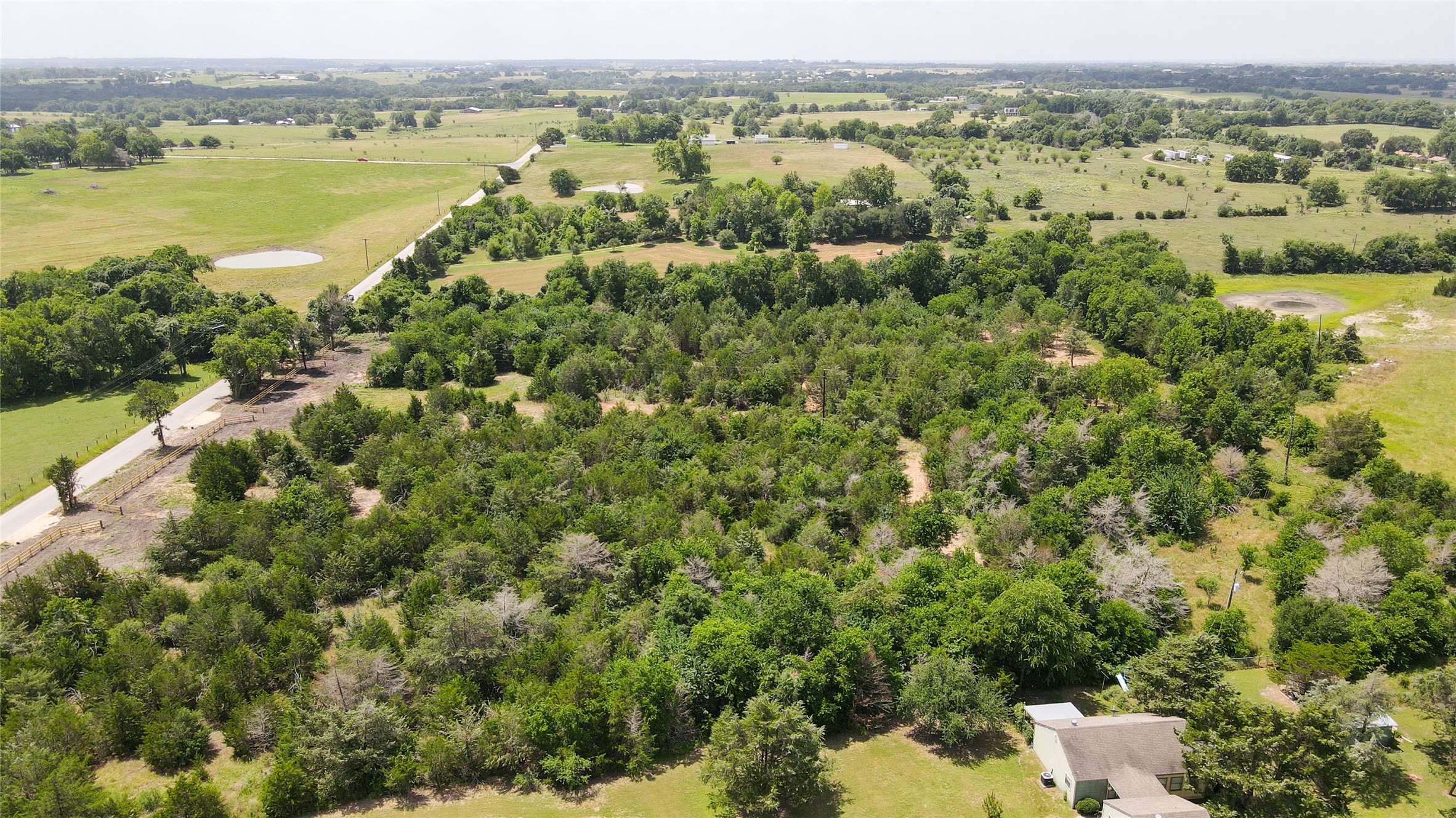 Lot 7 Wonder Hill Road Chappell Hill, TX 77426 - Photo 10 of 13 an aerial view of a houses with a yard and lake view