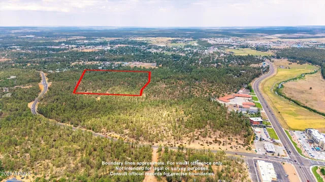 an aerial view of residential houses with outdoor space and swimming pool