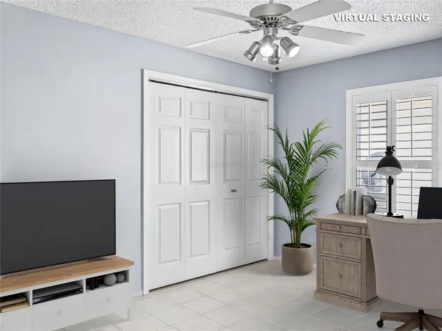 a living room with furniture and a potted plant